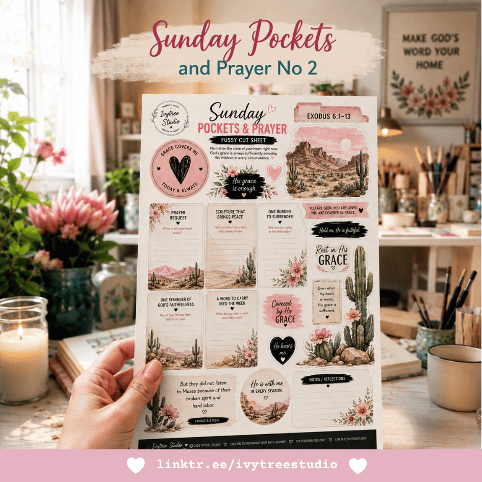 A hand holds a printed 'Sunday Pockets & Prayer' card in a beautifully decorated craft room. The card features a bohemian design with pink hearts, black text, cactus illustrations, and scripture verses.